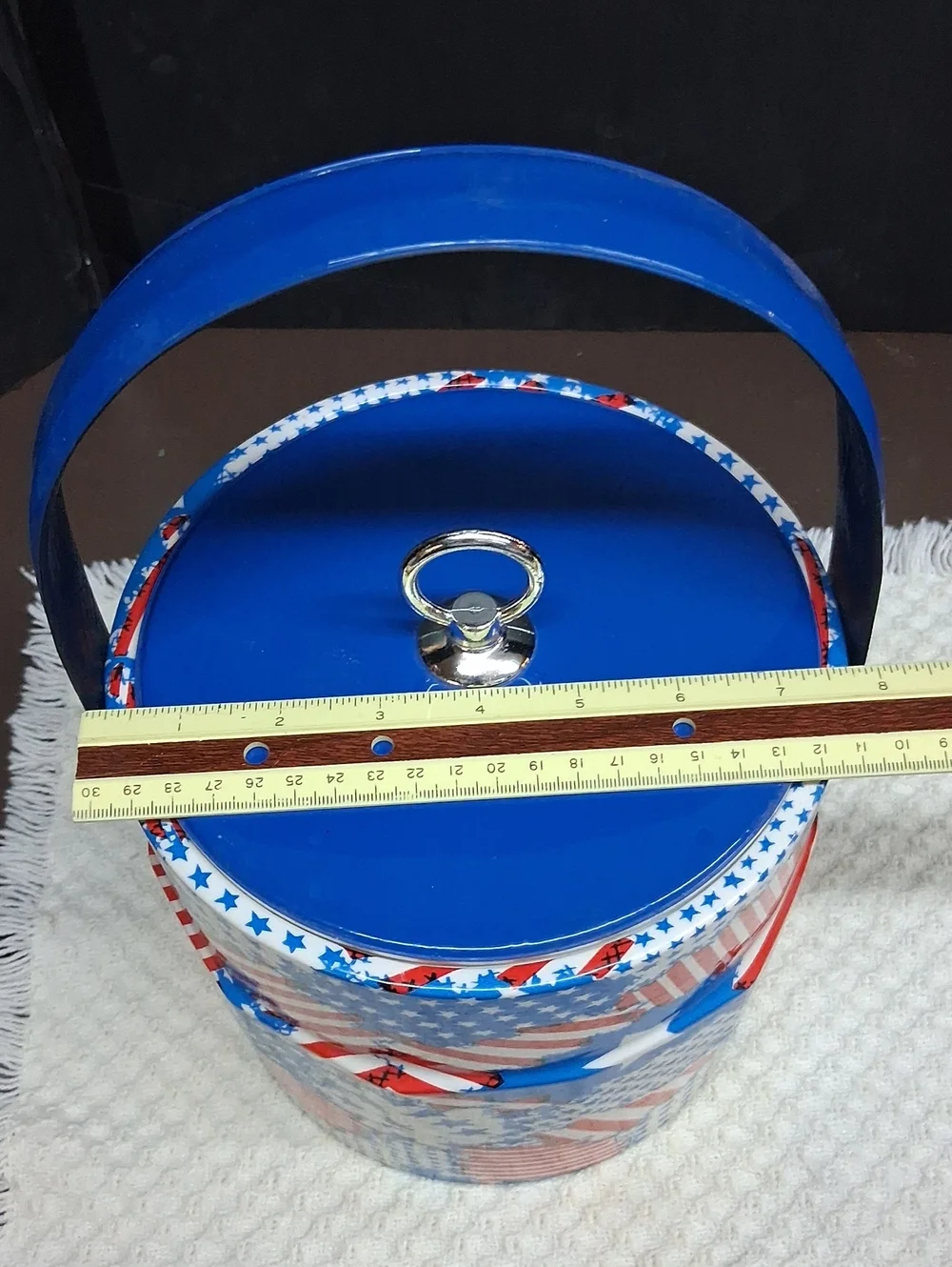 Patriotic Mr. Ice Bucket features a vibrant USA flag pattern& sturdy blue handle